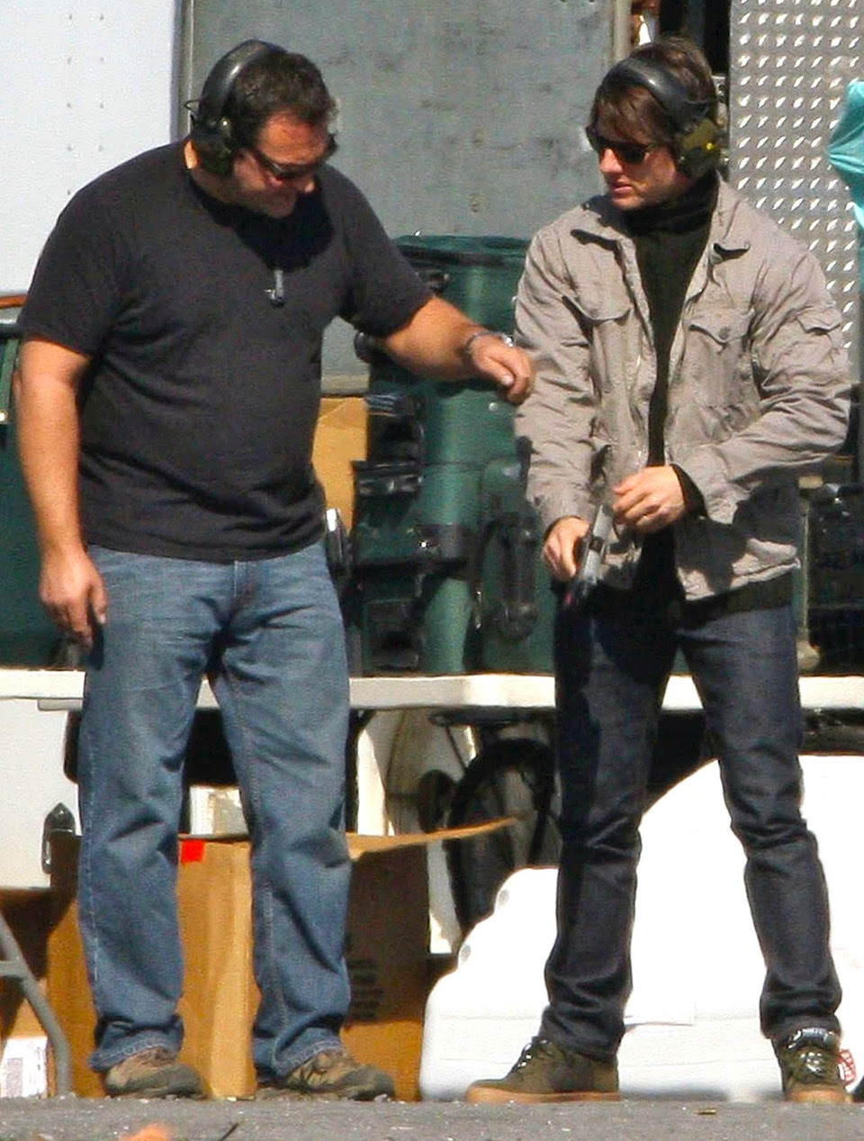 Armorer Guillaume Delouche works with actor Tom Cruise on proper firearm safety